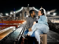 Living as digital nomads in New York City, Landing members Madison and Ivan pose on the Brooklyn Bridge